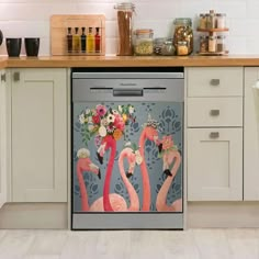 a dishwasher is decorated with flowers and flamingos