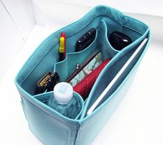 a blue bag filled with personal items on top of a table