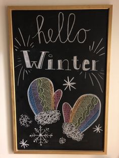 a chalkboard with two mittens on it and the words hello winter written below