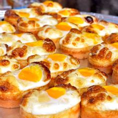 many small pastries are on a metal tray and ready to be served in the oven