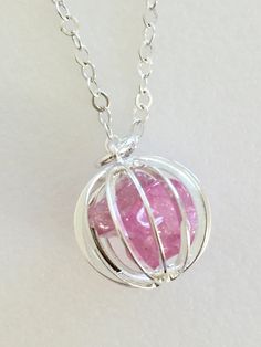 "Lovely gemstone necklace featuring 2 to 3 luscious pink polished natural tourmaline nuggets captured inside darling 15 mm vintage cage in plated Sterling silver and suspended from delicate Sterling silver cable chain. Nuggets range between 15 to 10 mm and were mined locally in the Himalayan Tourmaline Mines in San Diego County, California. Necklace available in 16\", 18\", and 20\" lengths. Chain closes with Sterling silver spring ring clasp. Also available on sparkling Sterling silver plated c Pink Tourmaline Jewelry For Healing, Healing Pink Tourmaline Jewelry, Paris Charm Bracelet, California Necklace, Cage Necklace, Caged Necklace, Lapis Necklace, San Diego County, Gifts For An Artist