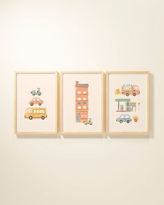 three framed pictures hanging on the wall in front of a white wall with cars and buildings