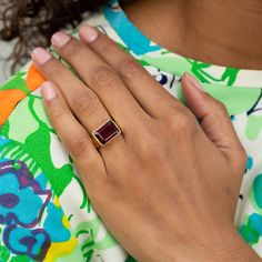 The Story Made from warm 18 karat yellow gold, this chic vintage ring centers around a rectangular garnet. A thick and substantial bezel and band frame the richly colored stone. Created in a beautiful sculptural shape, the classic signet ring style lines flow down the band. The size and scale feels amazing on the finger. We love it worn alone or styled alongside a handful of stacked rings for a "more is more" look. The Specs Style Number: R3229 Vintage, circa 20th century 18k yellow gold Garnet-