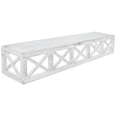 a white wooden shelf sitting on top of a wall