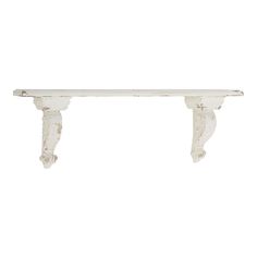 an old white shelf with two brackets on it