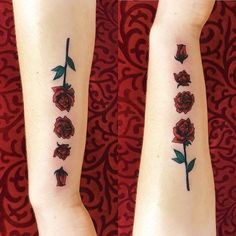 two roses on both arms with green leaves and red flowers in the middle one is black