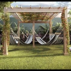 an outdoor area with hammocks, chairs and flowers on the grass in front of trees