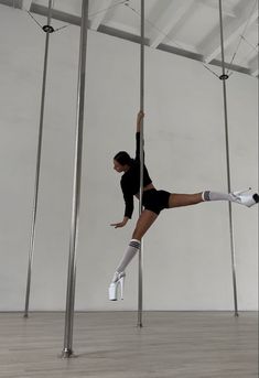 a woman standing on one leg in the air