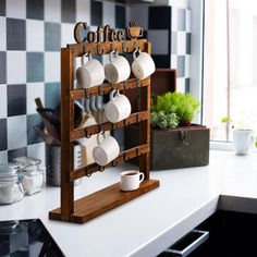 there is a coffee rack with cups on it