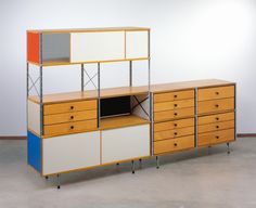 an old dresser with several drawers and a television on it's side, in front of a white wall