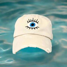 Protective Evil Eye Embroidered Hat - Unisex Fashion Cap for Spiritual Defense and Style Product Description: Step into the realm of spiritual protection and contemporary style with our exclusive Evil Eye Embroidered Hat. Meticulously designed for those who value both fashion and a touch of mystique, this unisex cap is more than just an accessory—it's your shield against negativity and a statement of your unique persona. Key Features: Authentic Evil Eye Design: The front of the hat showcases a c Summer Streetwear Hats With Embroidered Logo, Streetwear Cotton Hat With Embroidered Patch, Streetwear Hat With Embroidered Logo, Embroidered Cotton Hat For Streetwear, Blue Hats With Letter Print For Streetwear, Protective Charms, Meaningful Design, Evil Eye Design, Fashion Cap