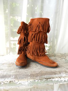 Vtg Buckskin Fringed Moccasins|Vtg Minnetonka 3 Layer Fringe Brown Boots|Vtg BOHO Fringed Boots sz 7 This is a great pair of vintage buckskin colored ladies 3 layer fringed Moccasins by Minnetonka.  These boots are slip on and have a low heel.  They are in nice condition with a few issues I pictured in the 3rd and last photo for you. A great pair of vintage Moccasins, perfect for a costume or casual wear! Thank you for visiting my Shop today!  Do stop back, I'm adding new merchandise almost daily. Buy with Confidence! Domestic Shipping:  FREE (ground shipping) International Shipping:  $49.95 (any overages to be refunded) Smoke free environment. International Bidders Welcome.   Combined shipping available on multiple purchase upon request.  Returns accepted within 14 days of receipt of your Fringed Boots, Fringe Moccasins, Boho Fringe, Fringe Boots, Ladies Shoes, Brown Boots, Low Heels, Moccasins, Flat Shoes Women