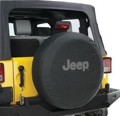 a jeep with a tire cover on it's back end and the word jeep written in large letters