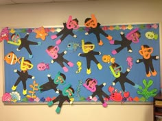 the bulletin board is decorated with colorful stickers and paper cutouts on it's sides