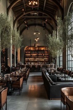 a restaurant with tables and couches in front of an arched ceiling filled with bookshelves