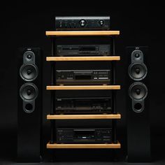 an array of speakers and audio equipment are stacked on top of each other in front of a black background