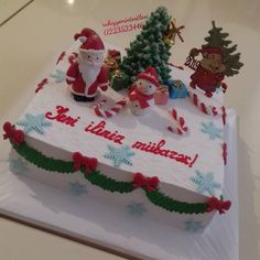 a cake decorated with santa claus and other holiday decorations