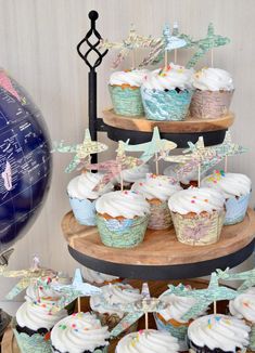 cupcakes are arranged on three tiered trays with flags and stars in them