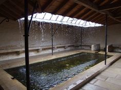 an indoor pool with water pouring from it