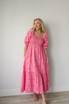 Discover a perfect blend of style and comfort with our Embroidered Gauze Midi Dress in Pink. The lightweight gauze fabric is adorned with delicate floral embroidery and a bold dark pink contrast, making it perfect for any occasion. The smocked waist adds a flattering fit and the midi length offers versatility for all body types. Embrace the hot pink hue and make a statement with this beautiful dress. gauzy cotton smocked bodice elbow length sleeves side pockets embroidered lined midi/maxi length Pink Short Sleeve Embroidered Dress For Spring, Feminine Midi Length Embroidered Dress With Floral Details, Feminine Midi-length Embroidered Dress With Floral Embroidery, Feminine Floral Embroidered Maxi Dress With Short Sleeves, Feminine Floral Embroidered Short Sleeve Maxi Dress, Feminine Short Sleeve Maxi Dress With Floral Embroidery, Spring Feminine Embroidered Dress, Feminine Spring Embroidered Dress, Spring Pink Midi Dress With Floral Embroidery