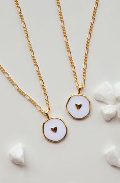 This is a new favorite minimal charm necklace. It's SO pretty. White charm with a gold heart in the middle, and it's hanging from our logan chain. Layer this up with a Luna necklace and you've got a really beautiful stack. Gold-filled is the closest alternative to solid gold. Gold filled jewelry has a thick layer of solid gold bonded onto the base layer, usually brass or sterling silver. Compared to gold plated which uses a process of electroplating that quickly dips your jewelry in gold, result Luna Necklace, 2024 Wardrobe, Solid Gold Charms, Etsy Promotion, Heart Charm Necklace, Gold Bond, Gold Heart, Gold Filled Jewelry, Gold Charm