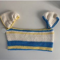 a crocheted blue and yellow purse with two matching mittens