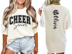 Celebrate your favorite cheerleader with our varsity style cheer senior shirt, personalized with the cheerleader's name and a pom pom on the back. This personalized shirt makes a perfect gift for cheerleaders and their teammates. COMFORT COLORS 1717 SHIRT: Unisex 100% US cotton - ethically grown and harvested Pre-Shrunk Fabric Relaxed Fit - Size up for a trendy oversized look Seamless Sides Double Needle Stitching Garment-dyed  CARE INSTRUCTIONS: Wash inside out with cold water Tumble dry on low Cheerleading Shirts Designs High School, Collegiate Customizable Tops For Cheerleading, Cheerleader Shirt Ideas, Customizable School Spirit Tops For Cheerleading, Customizable Tops For Cheerleading With School Spirit, Varsity Tops With Team Name For College Events, Collegiate Short Sleeve Top With Custom Print, Customizable Short Sleeve Varsity Tops, Collegiate Style Custom Print Short Sleeve Tops