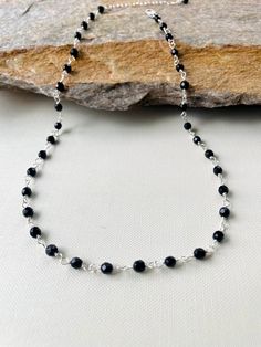 "Dainty onyx and Silver necklace.  Materials: 4mm genuine onyx faceted beads. Sterling silver wire. Sterling silver lobster clasp. Necklace length from 16\" to 30\"+ 3 inches sterling silver extended chain. * Custom orders are welcome. Onyx is a type of chalcedony, which is itself a form of microcrystalline quartz. Onyxes have straight, nearly parallel bands or layers of color, which allow skilled gem carvers to cut away material to create cameos and intaglios with extraordinary depth and contra Black Sterling Silver Jewelry With Polished Beads, Black Sterling Silver Necklace With Silver Beads, Gift Onyx Crystal Necklaces With Polished Beads, Silver Faceted Onyx Jewelry, Silver Onyx Beaded Necklace With Black Beads, Black Onyx Necklaces With Faceted Beads, Silver Onyx Necklace With Black Beads, Black Onyx Necklace With Faceted Beads, Onyx Necklaces With Faceted Round Beads