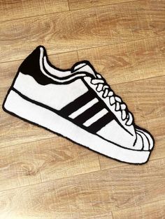 a black and white adidas sneaker rug on a wooden floor with wood floors