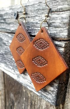 A simple Aztec design serves as the focal point for these warm, caramel leather earrings. Crafted by hand, this pair starts out as blank slates of premium veg-tanned leather and are hand-tooled and dyed for a truly unique, one-of-a-kind set.  These earrings are conditioned with beeswax, which keeps the leather supple and water resistant (see video). Edges and backs are finished, as well. Please remember that time and wear ages leather beautifully, transforming your pieces into truly personalized Brown Rectangular Bohemian Earrings, Bohemian Brown Rectangular Earrings, Brown Bohemian Concho Earrings, Southwestern Brown Concho Earrings, Southwestern Style Brown Concho Earrings, Southwestern Brown Leather Jewelry, Southwestern Style Brown Leather Jewelry, Adjustable Southwestern Brown Earrings, Stamped Leather Earrings