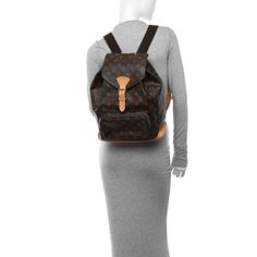 This is the authentic LOUIS VUITTON Monogram Montsouris GM Backpack. This backpack is crafted of monogram coated canvas with vachetta trim including shoulder straps, base, and a cinch cord. The bag also features brass hardware, an exterior zipper pocket and a flap with a belt closure. The top opens to a cocoa brown fabric interior with a patch pocket and a D ring. Cocoa Brown, Brown Fabric, D Ring, Brass Hardware, Authentic Louis Vuitton, Louis Vuitton Monogram, Patch Pocket, Shoulder Straps, Zipper Pocket