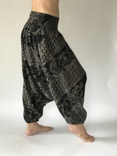 "These super soft rayon baggy unisex harem pants have the \"flow\", perfect of yoga or just a cool strolling. Comfort and character are what these pants are all about. They have the traditional sarong look & feel but a lot more practical when it comes to activity like yoga. As a bonus, they are convertible! Just pull them up and you get yourself a cute jumpsuit in a flash. Together with elastic cuff legs, you can wear them short or long. The pants have smock waist (wide bang elastic) with no Baggy Harem Yoga Pants, Hippie Style Harem Pants For Loungewear, Relaxed Fit Harem Pants For Yoga, Black Stretch Bohemian Harem Pants, Stretch Drop Crotch Harem Pants For Yoga, Yoga Harem Pants With Drop Crotch And Relaxed Fit, Baggy Harem Yoga Pants For Loungewear, Stretch Black Harem Pants For Festivals, Baggy Drop Crotch Harem Pants For Yoga