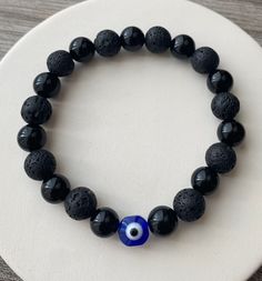 Beautiful classic evil eye bracelet made with black onyx and lava stone beads  Stay protected from negativity everywhere you go Good vibes only  bracelet can also double as diffuser bracelet just add your favorite essential oils and enjoy Evil Eye Jewelry Bracelet, Evil Eye Stone, Evil Eye Beaded Bracelet, Lava Bead Bracelet, Evil Eye Beads, Bracelet Inspo, Bracelets Ideas, Black Beaded Bracelets, Bead Charms Diy