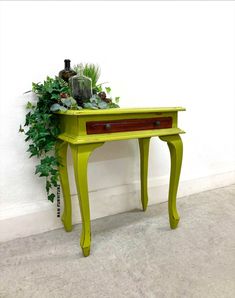 a small green table with a plant on top