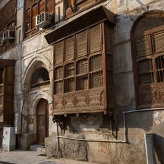 an old building with wooden windows and shutters