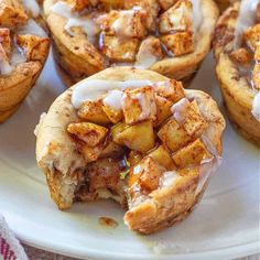 cinnamon rolls with icing on a white plate