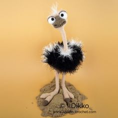 an ostrich is standing on top of sand