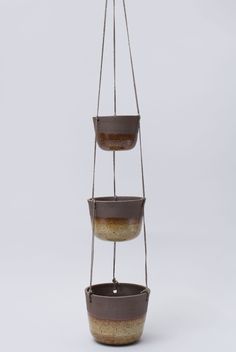 three tiered hanging planter with two pots on each side and one pot in the middle