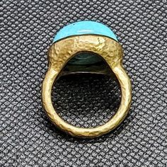 14k solid hammered yellow gold ring with 13.5 ct. 16.5 mm round shape natural spider turquoise. This item can also be ordered in rose or white gold with different color gemstones such as, green tourmaline, pink tourmaline, rutilated quartz, onyx, labradorite, white agate, all colors of chalcedony and aquamarine, please contact for a quote as each gemstone varies in price. I am a manufacturer of fine jewelry for over thirty years, loyalty & customer satisfaction has always been my ultimate go Gold Turquoise Ring With Gemstone, Unique Yellow Gold Oval Turquoise Ring, Handmade Yellow Gold Turquoise Ring, Handmade Turquoise Ring In Yellow Gold, Artisan Gold Turquoise Ring, Hammered Ring, Hammered Rings, White Agate, Swiss Blue Topaz