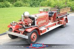 an old fire truck is parked on the side of the road