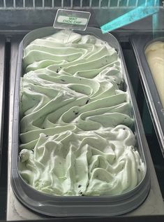 an ice cream display in a store filled with lots of white frosting and toppings