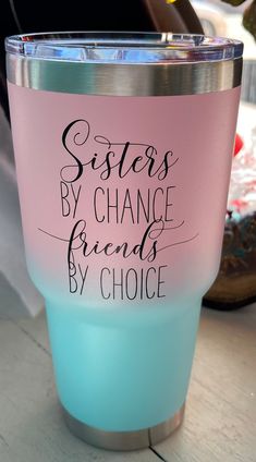 a pink and blue tumbler with the words sisters by chance, friends by choice on it