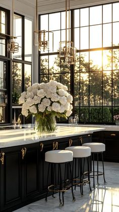 a vase with white flowers on top of a kitchen island