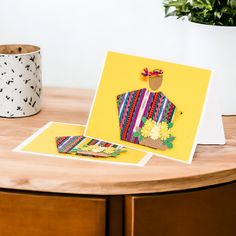 a table with some cards on it and a potted plant