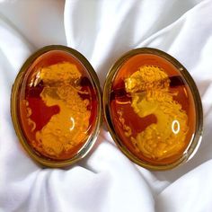 SAME DAY SHIPPING  Frozen in time, a beautiful woman sits by a pond under the light of the moon. Her delicate feet resting in the cold waters of spring nighttime. Beauty of mind incarnate. These vintage, carved amber cameo earrings oval cabochon earrings are handcrafted with solid 14k yellow gold. The hand chosen and polished amber cabochons have fabulous color and hand carvings of a womans portrait. They are approximately 30 CTTW. The glimmering gold is the perfect accentual treat to the eye. E Ruby Engagement Ring Gold, Estate Jewelry Rings, Vintage Gold Engagement Rings, Victorian Hand, Emerald Rings, Solid Gold Bracelet, Cameo Earrings, Anniversary Gift For Wife, Roman Fashion