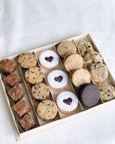 a box filled with different types of cookies and muffins