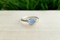 This ring is a perfect warm light blue on silver (upgrade to Sterling Silver) 20 gauge wire. Select from a range of sizes, the rings are true to size, and are not adjustable. Please contact with any questions or special requests. Silver Wire Rings, Something Blue Wedding, Wire Ring, Wire Rings, Something Blue, Blue Beads, Blue Wedding, Silver Wire, Glass Bead