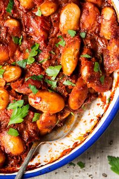 a bowl filled with stew and garnished with parsley