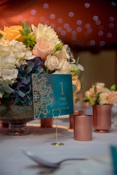 a table with flowers and place cards on it