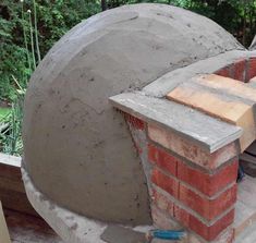 an outdoor brick oven in the process of being built